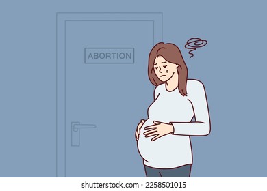 Upset pregnant woman stands near door with abortion sign needs psychologist after making difficult decision. Girl crying wants to terminate pregnancy due to unwanted insemination