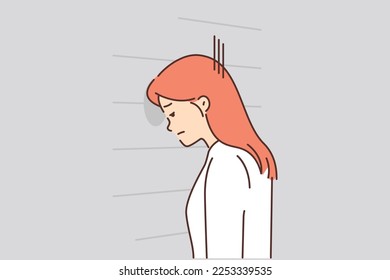 Upset woman banging her head against wall in despair looks stressed. Failed job interview concept