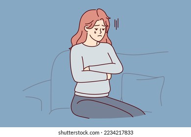 Upset woman crying sitting on couch because of breakup with boyfriend or death of loved one. Unhappy girl in casual clothes with arms crossed is going through after losing job. Flat vector image 