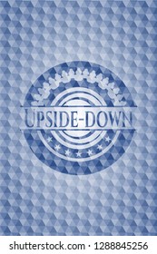 Upside-down blue emblem with geometric background.