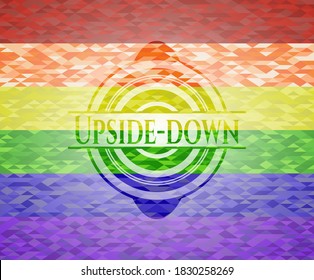 Upside-down emblem on mosaic background with the colors of the LGBT flag. 