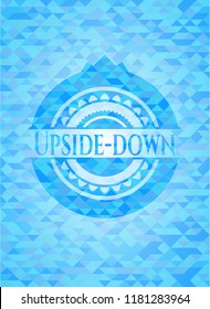 Upside-down light blue emblem with triangle mosaic background