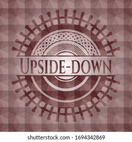Upside-down red seamless emblem with geometric pattern background.