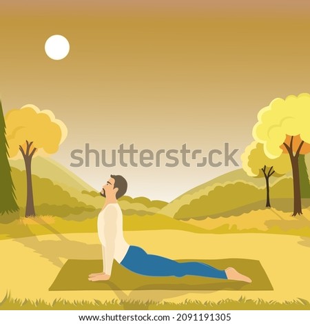 Upward Facing Dog or Urdha Mukha Shvanasana posture perfomed by handsome fit man outside in the field with mountines view in the mid day. Man is doing yoga at nature with autumn colors. 