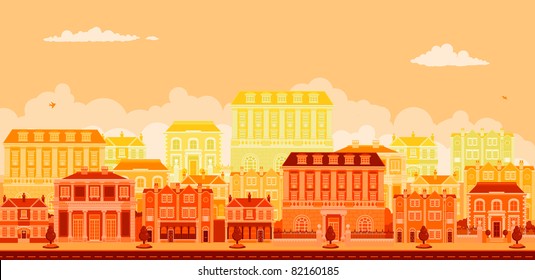 An urban tree lined avenue with smart townhouses in oranges, yellows and reds