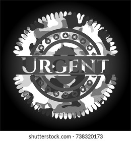 Urgent written on a grey camouflage texture