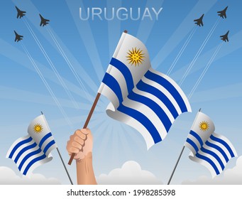 Uruguay flags fluttering under the blue sky