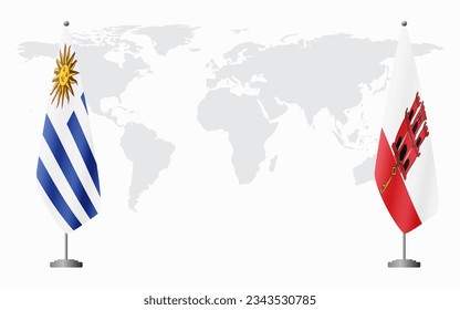 Uruguay and Gibraltar flags for official meeting against background of world map.