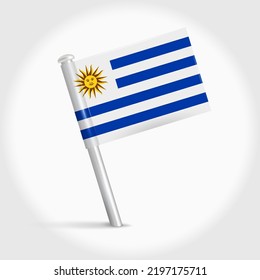 Uruguay map pin flag icon. Uruguayan pennant map marker on a metal needle. 3D realistic vector illustration.