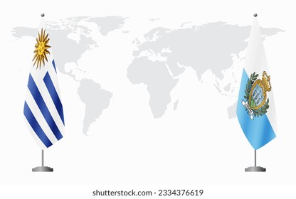 Uruguay and San Marino flags for official meeting against background of world map.