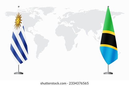 Uruguay and Tanzania flags for official meeting against background of world map.