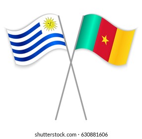 Uruguayan and Cameroonian crossed flags. Uruguay combined with Cameroon isolated on white. Language learning, international business or travel concept.