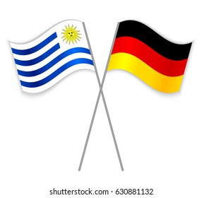 Uruguayan and German crossed flags. Uruguay combined with Germany isolated on white. Language learning, international business or travel concept.