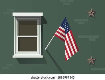 Bandera de los Estados Unidos colgada en la fachada de un edificio antiguo con una ventana blanca y anclas de estrellas de metal