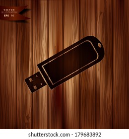 Usb flash drive web icon. Wooden background