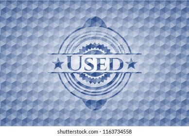 Used blue emblem with geometric background.