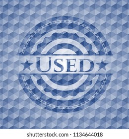 Used blue emblem with geometric pattern background.