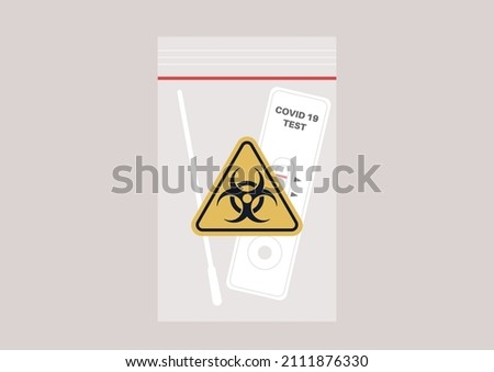 Used coronavirus rapid test kit in a plastic zip bag with a yellow triangle biohazard logo