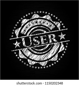 User chalkboard emblem on black board