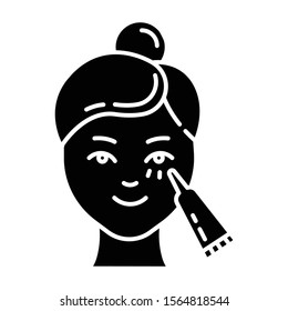 Using undereye cream glyph icon. Skin care procedure. Facial beauty treatment. Lifting and exfoliating effect. Eye makeup product. Silhouette symbol. Negative space. Vector isolated illustration