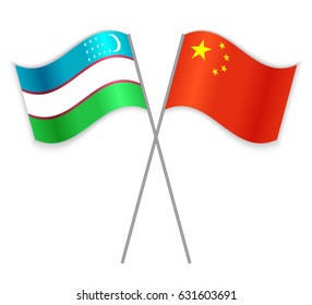 Uzbek and Chinese crossed flags. Uzbekistan combined with China isolated on white. Language learning, international business or travel concept.