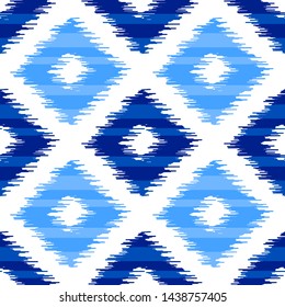 Uzbek ikat silk fabric pattern, indigo blue and white colors. Seamless geometric pattern, based on ikkat fabric style. Vector illustration. Carpet rug texture vector imitation.