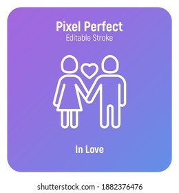 Valentine day: couple in love, girl and boy are holding hands and heart between them. Thin line icon. Pixel perfect, editable stroke. Vector illustration.