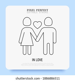 Valentine day: couple in love, girl and boy are holding hands and heart between them. Super thin line icon. Pixel perfect, editable stroke. Vector illustration.