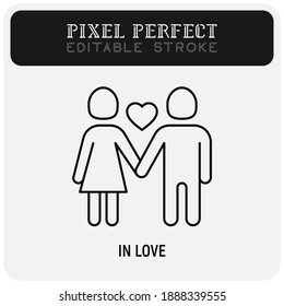 Valentine day: couple in love, girl and boy are holding hands and heart between them. Thin line icon. Pixel perfect, editable stroke. Vector illustration.