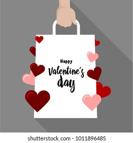 Valentine day sale concept. Hand holds paper package.Template or banner with package and hearts. Vector illustration. Isolated