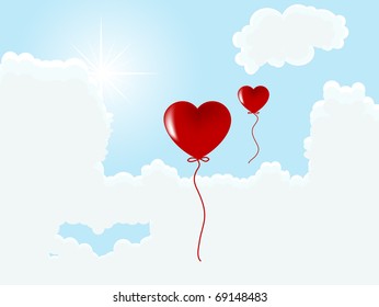 Valentine heart balloons against blue sky
