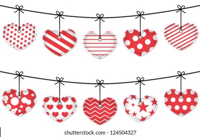 Valentine red textured hearts tied with bows hanging on white background. Vector