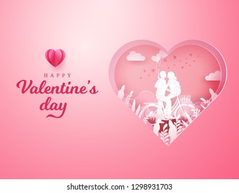 Valentine's Day background. couple sitting at one bicycle and looking each other with one hand holding heart shaped balloons on carved heart background. paper cut style vector illustration
