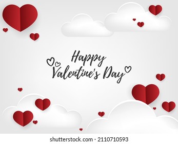 Valentines day background of many tiny red hearts on white sky background with clouds and Happy Valentines day text. Concept of love and Valentine day in paper art style.