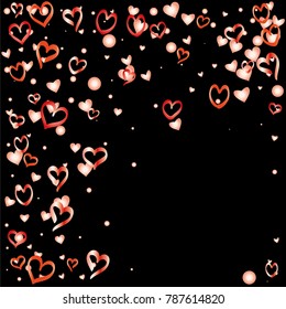 Valentines day background with random hand drawn falling red hearts isolated on black.