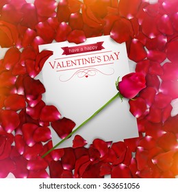 Valentines day background with a red rose and rose petals and a note.