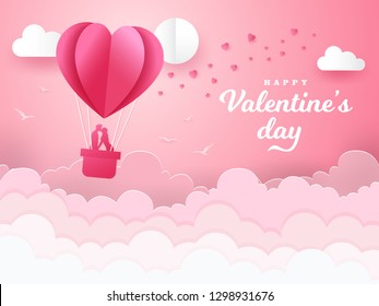 Valentine's Day background with romantic couple kissing and standing inside a basket of an air balloon. paper cut style vector illustration