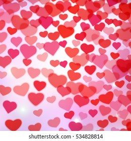 Valentines Day background with scattered blurred hearts.