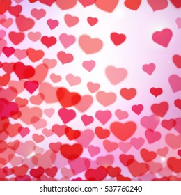 Valentines Day background with scattered blurred hearts.