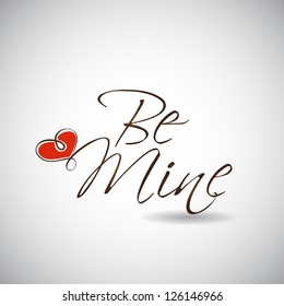 Valentines Day background with text Be Mine with glossy heart on grey.