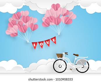 Valentine's day background of white bicycle and many heart shape balloons hang with love text flags on blue sky with clouds with tiny hearts and your copy space. Concept of love and Valentine day. 