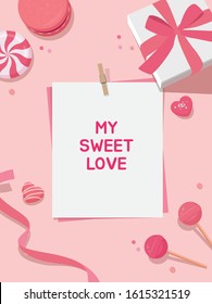 Valentine's Day background. White gift box tied with a pink ribbon, spiral candy and pink lollipops, macaroons, ribbon on pastel pink background with paper card note. Flat lay top view composition.