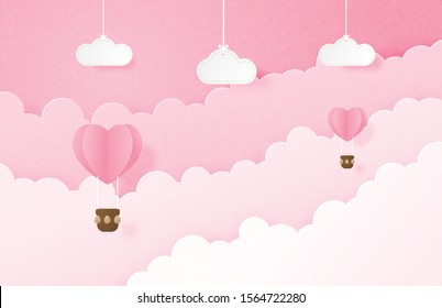 Valentine's day banner with heart shape hot air balloon floating in the sky and hanging clouds in paper cut style. Digital craft paper art concept.