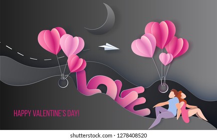 Valentines day card. Couple sitting near big letters LOVE on black background with air balloons. Vector paper art illustration. Paper cut and craft style.