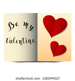 Valentine's day card with two hearts cut out of paper,with handwritten lettering.