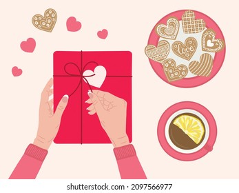 Valentine's day concept. White female hands open gift box wrapped into kraft paper. Top view table with romantic eco-friendly packaging, cup of tea, hearts gingerbread. Hand drawn vector illustration
