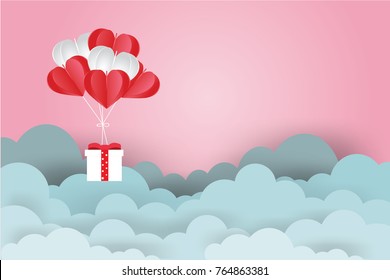 Valentine's day concept.Balloon  in a heart shape floating and Gift Box on in the air pink sky background.Paper and craft art