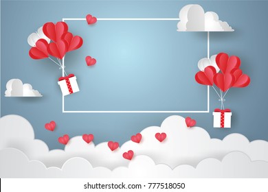 Valentine's day concept.Balloon  in a heart shape floating and Gift Box with text in white border on blue sky background.Paper and craft art