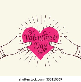 Valentine's day greeting card with pink heart in hands