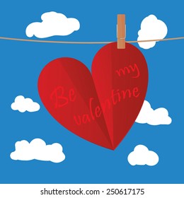 Valentine's day heart-shaped card clipped on rope on blue sky with clouds